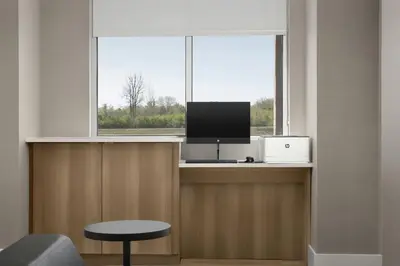 a room with a window with a computer and a tv at Residence Inn by Marriott Dayton Miamisburg in Miamisburg