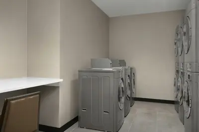 a laundry room with a row of washing machines at Residence Inn by Marriott Dayton Miamisburg in Miamisburg