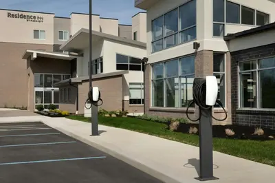 a building with two street lights on a sidewalk at Residence Inn by Marriott Dayton Miamisburg in Miamisburg