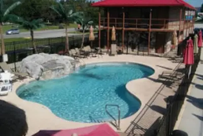 a large swimming pool with a rock in the middle at Beverly Hills Inn in Aberdeen