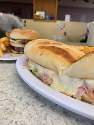 a sandwich and french fries on a white plate at Beverly Hills Inn in Aberdeen
