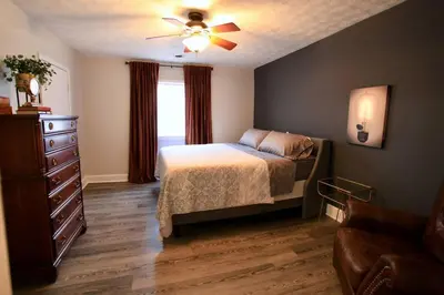 a bedroom with a bed and a ceiling fan at The Lounge - Downtown Chillicothe in Chillicothe