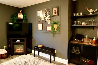 a living room with a tv and a fireplace at The Lounge - Downtown Chillicothe in Chillicothe