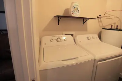 a white washer and dryer in a small room at The Lounge - Downtown Chillicothe in Chillicothe