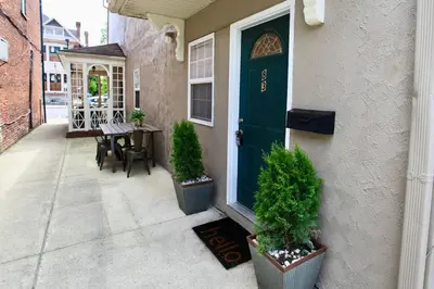 a front door of a house with a table and chairs at The Lounge - Downtown Chillicothe in Chillicothe