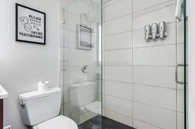 a bathroom with a toilet and a glass shower at Top Rated - Free Parking - 1-br Condo OTR in Cincinnati