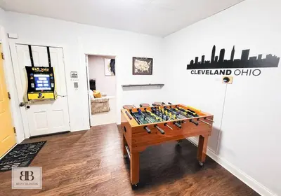 a room with a foosball table in front of a wall at Stylish King Bed, 2BDRM, 1 Mile to DTWN, Game Room in Cleveland