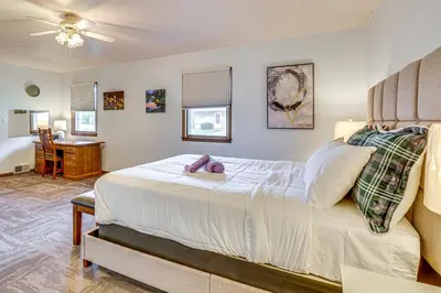 a bedroom with a bed with a teddy bear on it at Peaceful Home Near Youngstown Fenced Backyard! in Niles