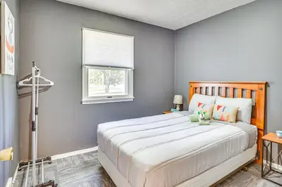 a bedroom with a large bed and a window at Peaceful Home Near Youngstown Fenced Backyard! in Niles