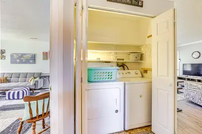 a kitchen and living room with a washer and dryer at Peaceful Home Near Youngstown Fenced Backyard! in Niles