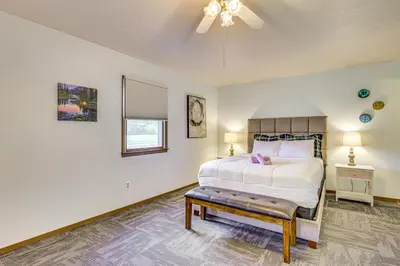 a bedroom with a bed and a ceiling fan at Peaceful Home Near Youngstown Fenced Backyard! in Niles