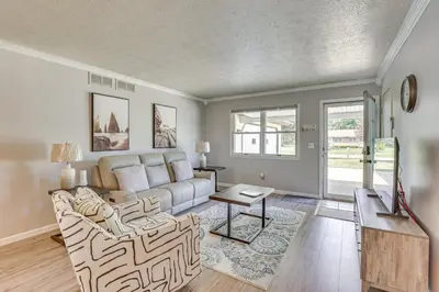 a living room with a couch and a table at Peaceful Home Near Youngstown Fenced Backyard! in Niles