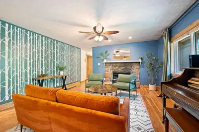 a living room with a couch and a piano at Cozy retreat on private estate with Hot Tub in Lancaster