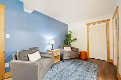a living room with two chairs and a table at Cozy retreat on private estate with Hot Tub in Lancaster