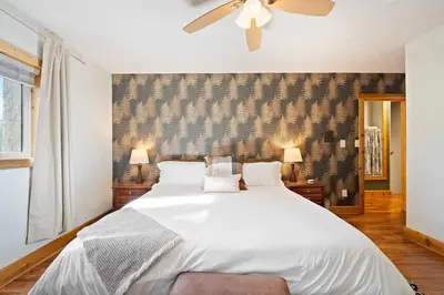 a bedroom with a white bed and a ceiling fan at Cozy retreat on private estate with Hot Tub in Lancaster
