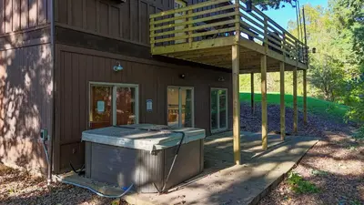 a house with a deck on the side of it at Cozy retreat on private estate with Hot Tub in Lancaster