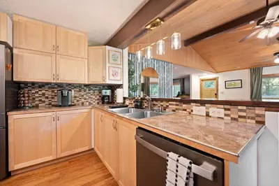 a kitchen with wooden cabinets and a sink at Cozy retreat on private estate with Hot Tub in Lancaster