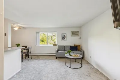 a living room with a couch and a table at Scenic towers 3012 I Cozy & Comfy I Free Parking in Parma