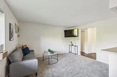 a living room with a couch and a table at Scenic towers 3012 I Cozy & Comfy I Free Parking in Parma