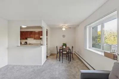 a living room with a table and chairs and a window at Scenic towers 3012 I Cozy & Comfy I Free Parking in Parma