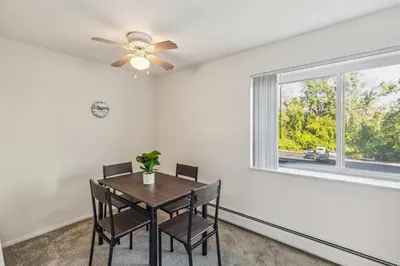 a dining room with a table and chairs and a window at Scenic towers 3012 I Cozy & Comfy I Free Parking in Parma