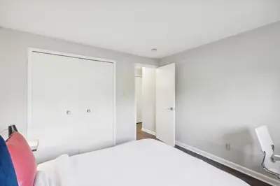 a bedroom with a white bed and a large mirror at Scenic towers 3020 I Cozy & Comfy I Free Parking in Parma