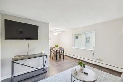 a living room with a flat screen tv on a wall at Scenic towers 3020 I Cozy & Comfy I Free Parking in Parma