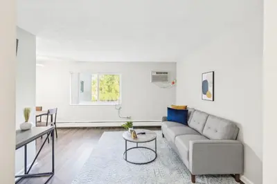 a living room with a couch and a table at Scenic towers 3020 I Cozy & Comfy I Free Parking in Parma