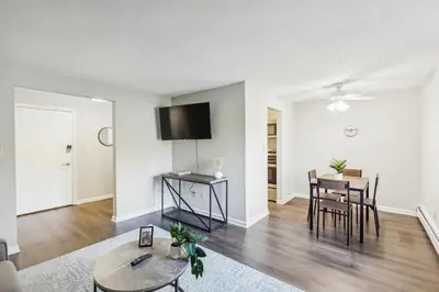 a living room with a table and a dining room at Scenic towers 3020 I Cozy & Comfy I Free Parking in Parma