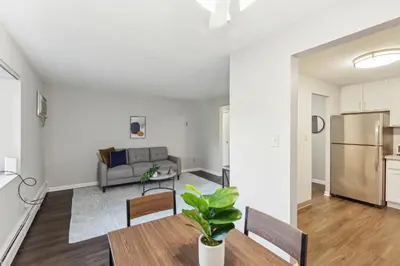 a living room with a couch and a table at Scenic towers 3020 I Cozy & Comfy I Free Parking in Parma