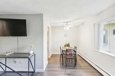 a dining room with white walls and a table and chairs at Scenic towers 3020 I Cozy & Comfy I Free Parking in Parma