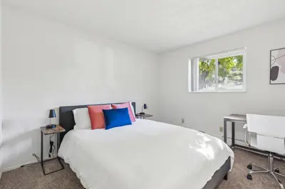 a white bedroom with a bed and a window at Scenic towers 3102 I Cozy & Comfy I Free Parking in Parma