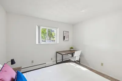 a bedroom with a bed and a desk at Scenic towers 3102 I Cozy & Comfy I Free Parking in Parma