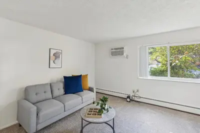 a living room with a couch and a table at Scenic towers 3102 I Cozy & Comfy I Free Parking in Parma
