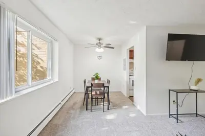 an empty living room with a table and chairs at Scenic towers 3102 I Cozy & Comfy I Free Parking in Parma
