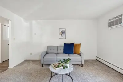 a living room with a couch and a table at Scenic towers 3102 I Cozy & Comfy I Free Parking in Parma
