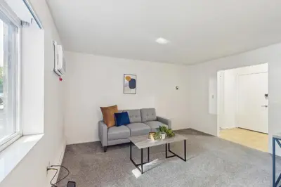 a living room with a couch and a table at Scenic towers 3105I Cozy & Comfy I Free Parking in Parma