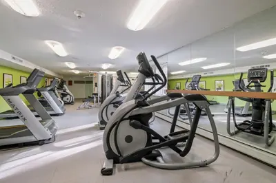 a gym with treadmills and elliptical machines at Scenic towers 3105I Cozy & Comfy I Free Parking in Parma
