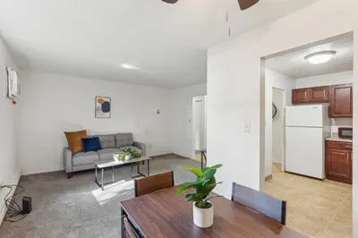 a kitchen and living room with a couch and a table at Scenic towers 3105I Cozy & Comfy I Free Parking in Parma