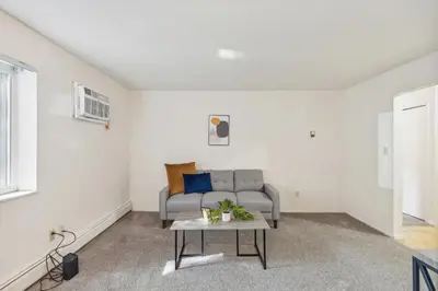 a living room with a couch and a table at Scenic towers 3105I Cozy & Comfy I Free Parking in Parma
