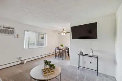 a living room with a tv and a table at Scenic towers 3217I Cozy & Comfy I Free Parking in Parma
