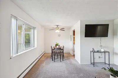 a living room with a table and a flat screen tv at Scenic towers 3217I Cozy & Comfy I Free Parking in Parma