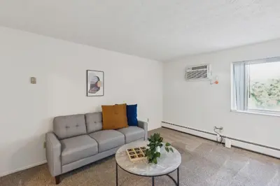a living room with a couch and a table at Scenic towers 3217I Cozy & Comfy I Free Parking in Parma