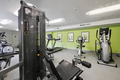 a gym with several treadmills and exercise bikes at Midtown 3229I Cozy & Comfy I Free Parking in Parma