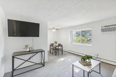 a living room with a flat screen tv on the wall at Midtown 3229I Cozy & Comfy I Free Parking in Parma