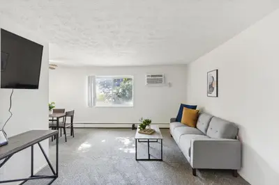 a living room with a couch and a flat screen tv at Midtown 3229I Cozy & Comfy I Free Parking in Parma