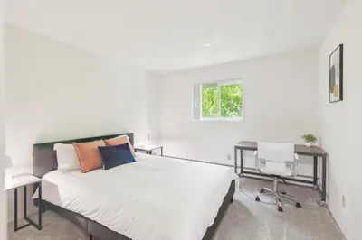 a bedroom with a bed and a desk and a window at Midtown 3402I Cozy & Comfy I Free Parking in Parma