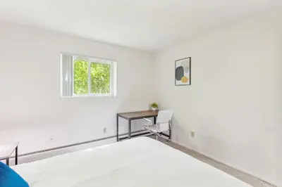 a white bedroom with a bed and a window at Midtown 3402I Cozy & Comfy I Free Parking in Parma