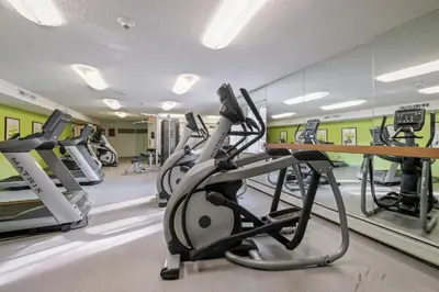 a gym with treadmills and elliptical machines at Midtown 3402I Cozy & Comfy I Free Parking in Parma