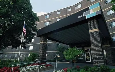 a building with an american flag in front of it at Midtown 3402I Cozy & Comfy I Free Parking in Parma